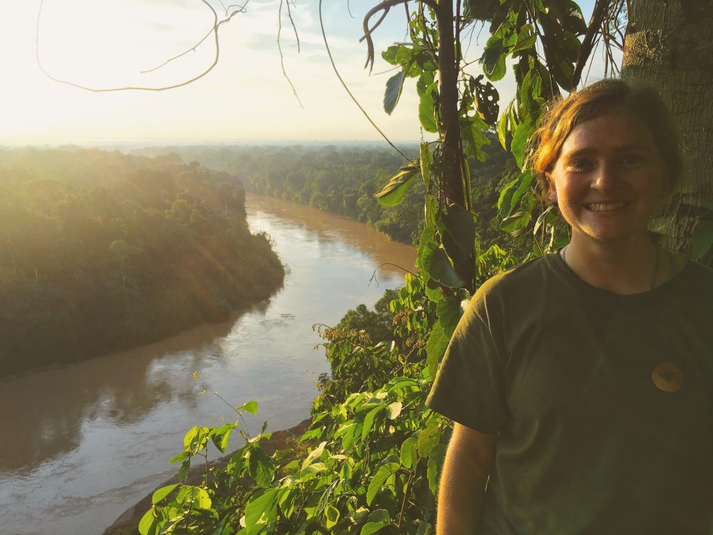 Danielle at the lookout point on Mirador Cliff, where one can view a dense swath of treetops over the horizon.